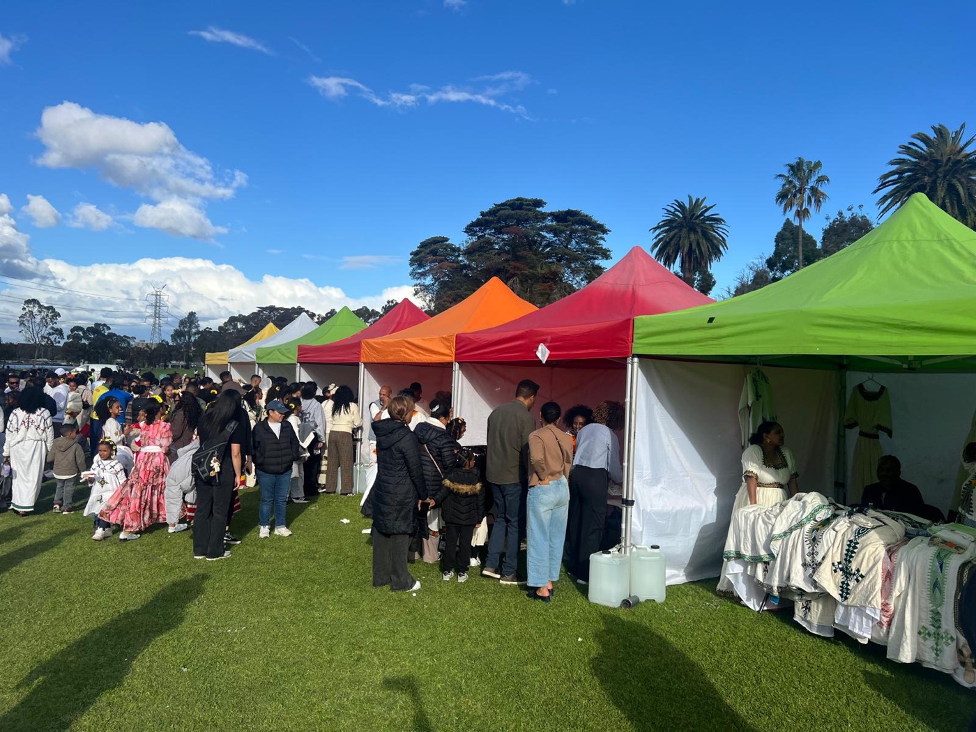 Market stalls at the celebration, with traditional habesha dresses on display