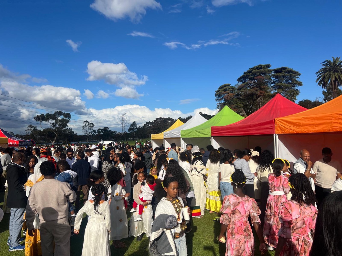 Families in traditional Ethiopian dress browsing the colourful stalls